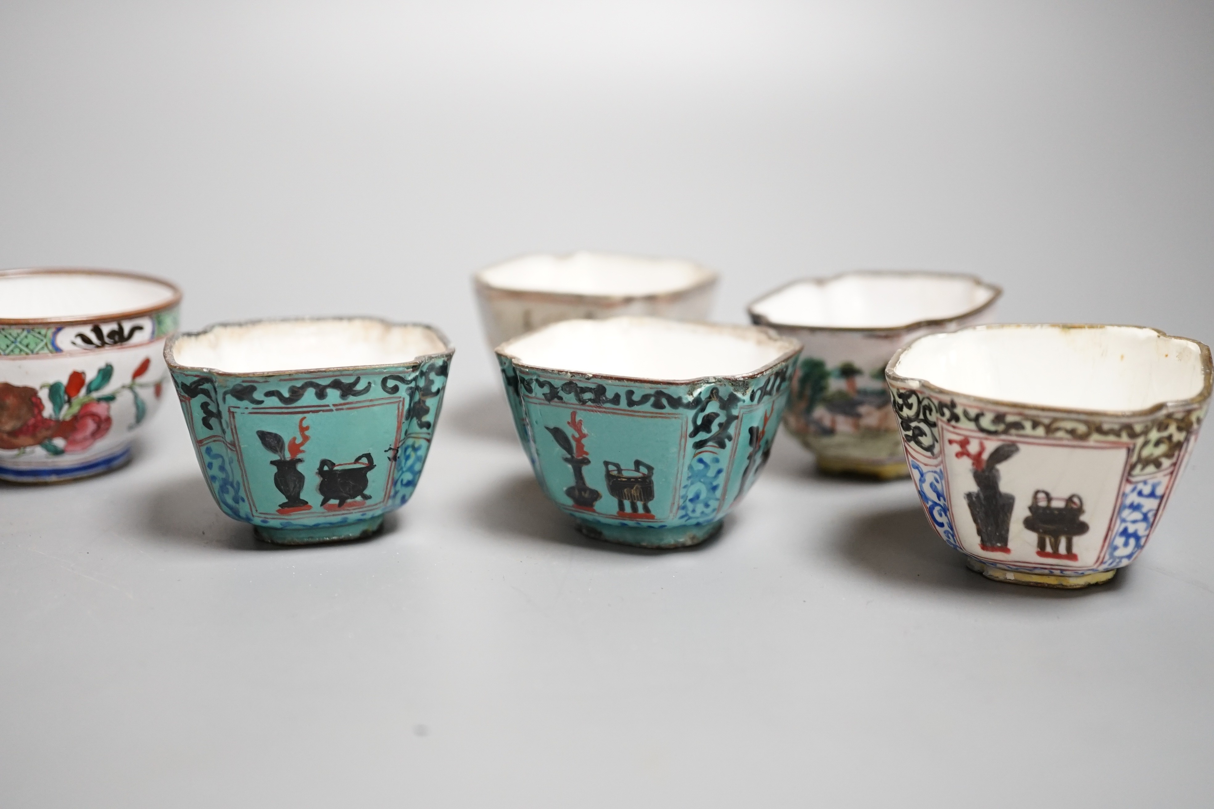 Nine pieces of Chinese Canton enamel wares, Qianlong period, including two enamel dishes, two rice spoons, and six various cups, largest 11cm